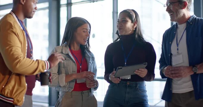 Diverse coworkers reacting to Black man gesturing coffee cup, sharing tablet screens for feedback