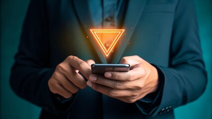 A person in a business suit holding a smartphone with a glowing orange triangular hologram projecting from its screen, symbolizing modern technology and digital interaction.