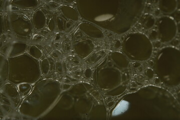 water drops on a glass, soap bubbles on a yellow background