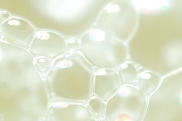 Abstract background, foamy moisture, soap bubbles on a yellow background
