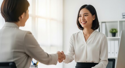 Asian Business Women Shake Hands at Meeting With a Smile Gesture