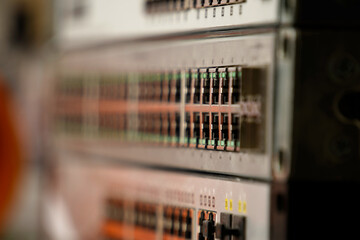 Close-up of stacked network switches with rows of RJ45 ports and status LEDs, shallow depth of field—enterprise data center hardware symbolizing connectivity, bandwidth and reliable IT infrastructure.