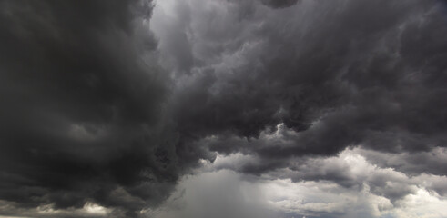 Dark storm clouds fill the sky creating a dramatic and intense atmosphere, weather change,storm formation,heavy rain,climate impact,nature’s power,and the unpredictable force of the environment.