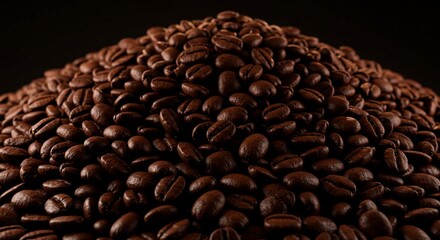A close up shot showcasing a large pile of roasted coffee beans against a dark background in detail