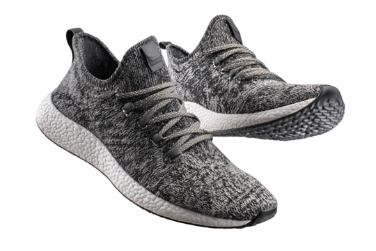 Pair of graphite knit running shoes with reflective thread and textured soles, isolated on transparent background.

