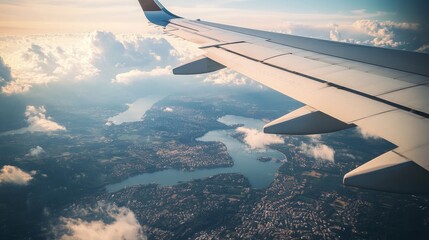 Aerial view from an airplane wing showcasing a scenic landscape with lakes, rivers, and clouds, highlighting the beauty of nature from above during a flight journey