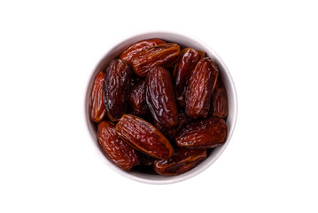 Dried dates in a ceramic plate, arabic food for the ramadan table. Dried dates as a food backgrounds