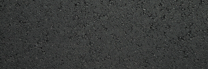 New dark black asphalt background. Closeup. Wide banner. Empty place for text. Top down view.