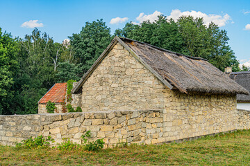 Rural, Central European village Stone building with thatched roof and irregular stones Multiple...