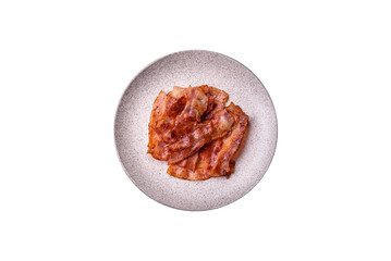 Fried pork bacon slices or strips as a breakfast ingredient. Fried bacon
