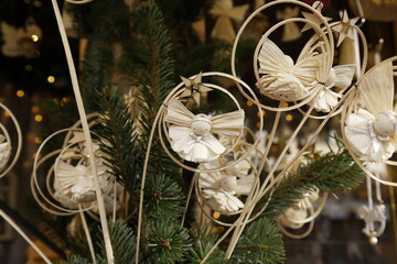 Handmade straw angel ornaments on christmas tree