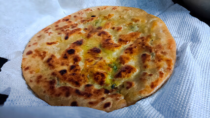 Golden, crispy aloo paratha stuffed with spiced potatoes and herbs, cooked to perfection with ghee, making a delicious and comforting Indian breakfast or meal.