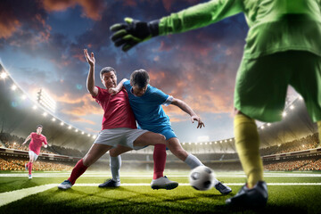 Soccer championship. Soccer arena full of fans. Sports concept. Sunset on stadium. Soccer. Professional soccer players in action. Tackling the ball