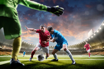 Sunset on stadium. Soccer. Professional soccer players in action. Tackling the ball. Soccer championship. Soccer arena full of fans. Sports concept
