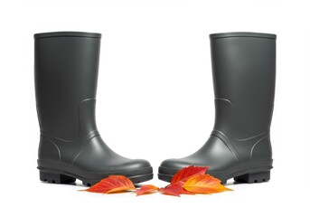 Rubber boots displayed with vibrant autumn leaves on white background  