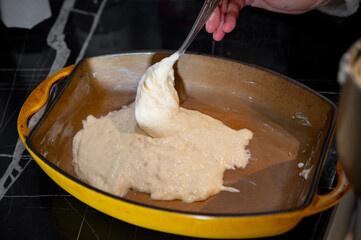 Pouring Liquid Dough into Ceramic Baking Dish