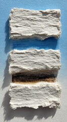 Textured paper layers evoke abstract natural elements with soothing blue and earthy brown tones creating serene minimalist art