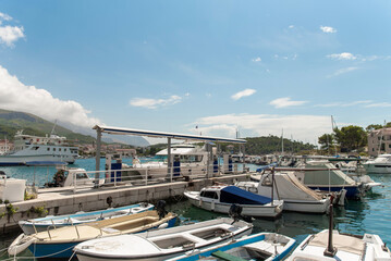 Marina fuel dock with motorboats in sunny bay