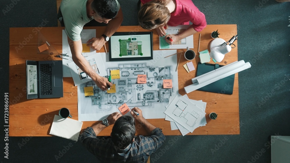 Poster top down view of civil engineer handed document while looking at blueprint. aerial view of architect