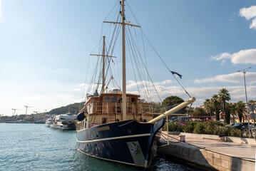 Classic motor-sailing vessel moored at harbor quay