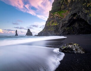 Dramatic black sand beach at sunrise