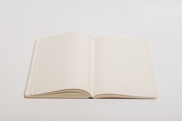 Open Blank Notebook with Cream Pages on White Background