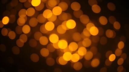 Dreamy golden bokeh sparkles on a dark background creating an atmospheric glowing effect.