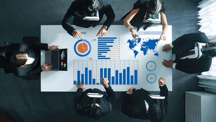 A diverse business team engages in collaborative data analysis using virtual reality technology in a modern office setting, showcasing innovative workflow processes. Axiom