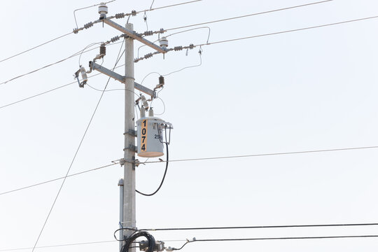 A modern electrical transformer, mounted on a concrete pole and connected to the power distribution system. A blue sky is visible in the background. Guadalajara, Jalisco, Mexico, Sept. 18, 2025. CFE