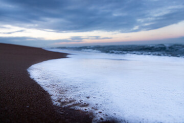 foamy wave at sunset