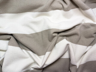 Fototapeta premium Fabric close up, white and beige, light fabric, cotton, clothing, flat lay, copy space, top view. High quality photo