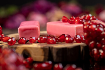 red ripe pomegranate with large juicy grains and sweet curd cheese in pink glaze, sweet red...
