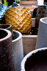 Colorful pots on display in a market in Denmark showcasing unique designs and vibrant colors for gardening enthusiasts