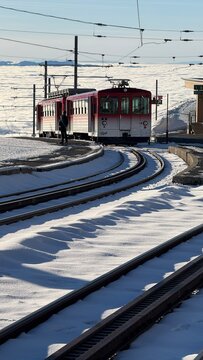 Rigi-Kulm, Switzerland - November 29, 2024: Vitznau-Rigi mountain railway at the Rigi-Kulm terminus on the summit in the snowy winter landscape.