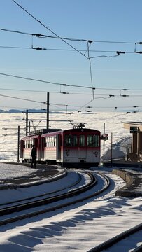 Rigi-Kulm, Switzerland - November 29, 2024: Vitznau-Rigi mountain railway at the Rigi-Kulm terminus on the summit in the snowy winter landscape.