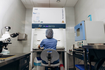 A young scientist working at a medical clinic conducts experiments in a laboratory.