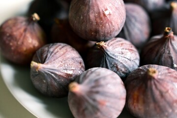Close-up of fresh ripe figs with purple shades. Perfect for concepts of healthy eating, vegan diet, Mediterranean lifestyle, and organic seasonal fruit.
