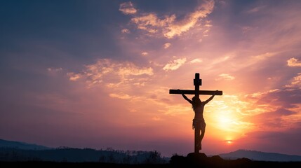 Silhouette of a cross with Jesus Christ at sunset, symbolizing faith and hope.