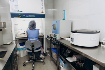 A young scientist working at a medical clinic conducts experiments in a laboratory.