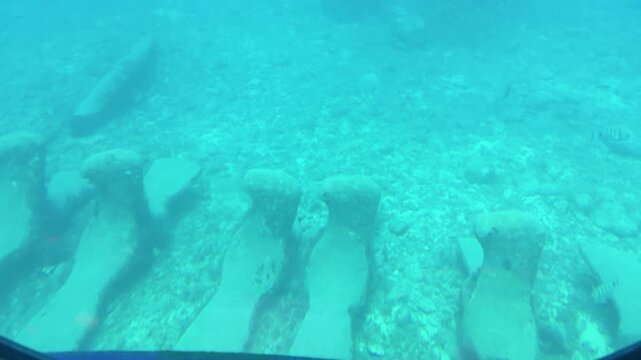 Ocean observed through large porthole of The Golden Shark, a modern recreational submarine powered by electric motors in Puerto de Mog&aacute;n, in Gran Canaria.