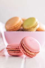 Different flavors of macarons. Colourful macaroons on white table.