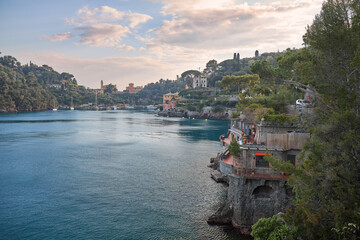 Coastal view of a tranquil Italian village by the water during golden hour