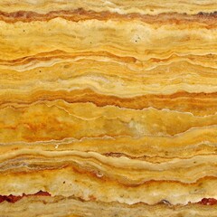 Closeup abstract texture of polished yellow and orange onyx stone with wavy horizontal layers