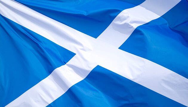 Scottish flag with white diagonal cross on blue field, flying on flagpole, symbolizing heritage and identity.