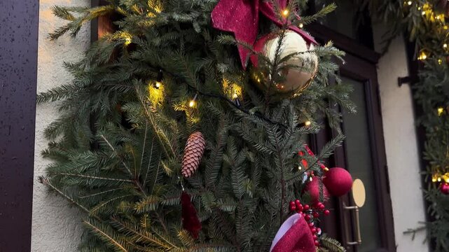Festive street decoration adorned with evergreen garlands, red ornaments, and twinkling lights, creating a warm holiday atmosphere for New Year celebrations