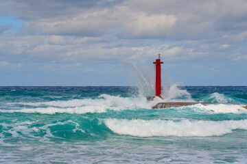 A red lighthouse among the waves in Varadero.