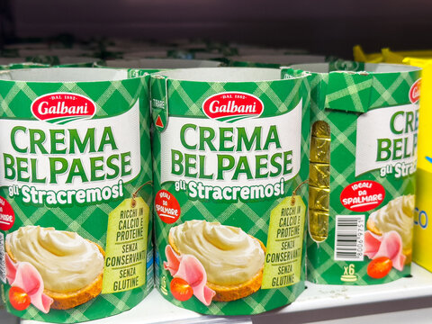 Gemona, Italy - September 24, 2025: Galbani Crema Belpaese Stracremosi cheese spread cans displayed on supermarket shelf, showcasing vibrant packaging and appealing product design