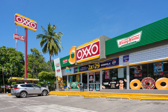 oxxo covered with krispy kreme advertising, collaboration between Krispy Kreme and oxxo. Oxxo franchise convenience store. Guadalajara, Jalisco, Mexico, August 24, 2024. FEMSA