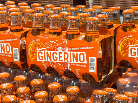 Gemona, Italy - September 24, 2025: Gingerino beverage bottles arranged in a vibrant display showcasing the bright orange packaging and refreshing drink, perfect for summer gatherings and celebrations