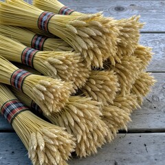 Several bundles of wheat are neatly tied with patterned plaid ribbons, creating an organized display 